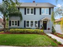 Two-story gray house with black shutters, landscaped yard, and a walkway at 1375 Suffolk Rd, Winter Park, FL 32789