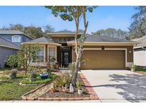 Charming home with a meticulously landscaped front yard, an inviting entrance and a two-car garage at 1721 Lakelet Loop, Oviedo, FL 32765