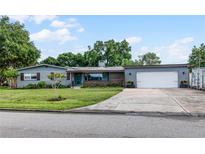 Charming ranch home with a two-car garage and well-manicured lawn at 1792 Killarney Dr, Winter Park, FL 32789