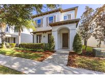 Two-story home with a charming front porch and landscaped yard at 11560 Ashlin Park Blvd, Windermere, FL 34786