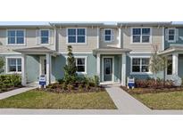 Two-story townhouses with light-grey siding, landscaping, and paved walkways at 12455 Shipwatch St, Orlando, FL 32832