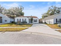 House exterior with landscaping and driveway at 1360 Cherrybark Rd, Apopka, FL 32703