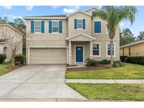 Two-story house with blue accents and a two-car garage at 3464 Julius Estates Blvd, Winter Haven, FL 33881