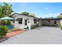 Cute bungalow with carport, patio furniture, and well-manicured landscaping at 528 Broadway Ave, Orlando, FL 32803