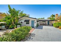 Charming single-story home with mature landscaping and a bright blue front door at 528 Broadway Ave, Orlando, FL 32803