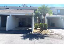 Exterior view of condo building, showing parking and landscaping at 5429 Vineland Rd # S, Orlando, FL 32811