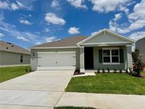Charming single-story home with a well-manicured lawn and attached two-car garage at 5489 Hayloft Dr, Apopka, FL 32712