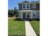 Charming two-story home with a well-maintained lawn and inviting walkway leading to the front door at 6034 Galloping Dr, Apopka, FL 32712