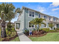 Two-story light blue home with palm trees and landscaping at 12439 Shipwatch St, Orlando, FL 32832