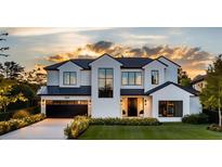 Stunning modern home featuring a manicured lawn, black trim, and black garage door at sunset at 1830 Park Lake St, Orlando, FL 32803