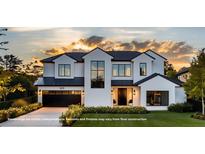 Stunning modern home with black trim, a two-car garage, beautiful landscaping, and an inviting entrance at 1830 Park Lake St, Orlando, FL 32803
