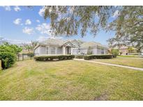 House with a well-maintained lawn and walkway at 2225 Kettle Dr, Orlando, FL 32835
