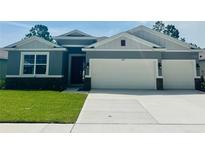 Charming single-Gathering home with a two-car garage, beautiful landscaping, and a well-maintained lawn at 3221 Arch Ave, Ormond Beach, FL 32174
