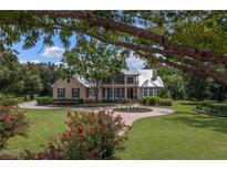 Two-story home with circular driveway and manicured lawn at 3413 Lilas Ct, Windermere, FL 34786