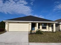 Newly constructed home with a two-car garage and well-manicured lawn at 4486 Segafield, St Cloud, FL 34773