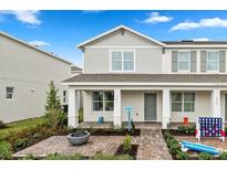 Two-story home with gray exterior, landscaped yard, and firepit at 676 Kimber Ln # 37, Debary, FL 32713