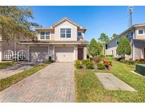 Two-story townhome with two-car garage and landscaped front yard at 8321 Bella Vida Cir # 8321, Davenport, FL 33896
