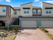 Modern three-story townhome with two-car garage and landscaped front at 1496 Broad Wing Ln, Winter Park, FL 32792