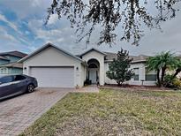 Single-story house with attached garage and landscaped lawn at 2739 Star Grass Cir, Kissimmee, FL 34746