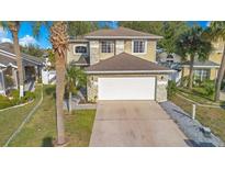Two-story house with a white garage door and stone accents at 3251 Brewster Dr, Kissimmee, FL 34743
