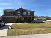 Two-story house with a large front yard and attached garage at 438 Palm Dr, Sanford, FL 32771