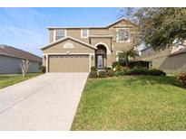 Two-story house with a large driveway and landscaped yard at 4847 Havilland Dr, Mount Dora, FL 32757