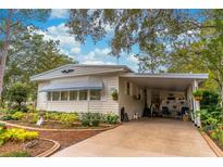 Charming single-story home with landscaped yard, covered carport, and inviting curb appeal at 598 E Club Blvd, Lake Mary, FL 32746