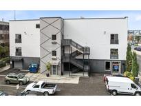 Modern building exterior with parking and multiple entrances at 62 W Colonial Dr # 205, Orlando, FL 32801