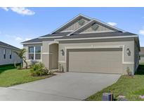 Charming single-story home featuring a two-car garage and well-maintained lawn at 1864 Maple Plum Ct, Sanford, FL 32771