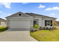 Charming single-story home featuring a two-car garage and well-manicured front yard at 5571 Creek Haven Way, Lakeland, FL 33810