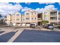 Front view of a multi-unit residential building with parking at 6413 Astor Village Ave # 305, Orlando, FL 32835