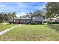 Ranch style home with brick facade and spacious lawn at 680 Avenue N Se, Winter Haven, FL 33880