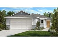 Single-story home with a two-car garage and landscaped lawn at 8376 Wilder Pines Ave, Lakeland, FL 33809