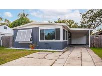 Charming ranch home with gray exterior, white trim, and a covered carport at 1012 N Ferncreek Ave, Orlando, FL 32803