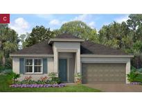 Charming single-story home with a two-car garage, a cozy front porch, and beautifully landscaped front yard at 1343 Foran Manor Rd, Haines City, FL 33844