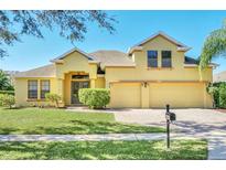 Beautiful two-story house with a two-car garage and well-manicured lawn at 1580 Prairie Oaks Dr, St Cloud, FL 34771