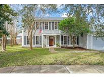 Two-story house with gray siding, landscaping, and a walkway at 1718 Errol Woods Dr, Apopka, FL 32712