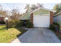 Brick home with attached garage and landscaped yard at 3934 Ne 21St Ln, Ocala, FL 34470