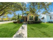 Charming bungalow with green metal roof, landscaping, and walkway at 436 E Jersey St, Orlando, FL 32806