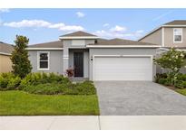 Charming single-story home with a manicured lawn and a two-car garage at 507 Silver Palm Dr, Haines City, FL 33844