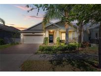 Charming single-Gathering home featuring a manicured lawn and welcoming entryway at 10060 Pecan Hickory Way, Orlando, FL 32832