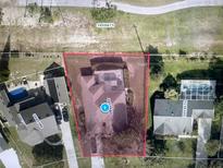 Aerial view of the property showcasing a pool, backyard, and proximity to other homes and greenery at 14101 Vista Del Lago Blvd, Clermont, FL 34711