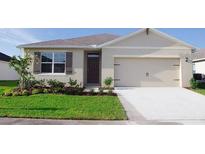 One-story home with two-car garage and landscaped lawn at 1542 Wax Myrtle Way, Haines City, FL 33844