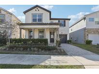 Two-story house with a front porch and landscaped yard at 2052 Fleming Mist Pl, Kissimmee, FL 34747