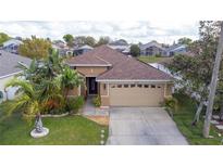 Charming single-Gathering home boasts an attached two-car garage and manicured lawn at 234 Elderberry Dr, Davenport, FL 33897