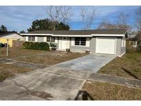 Ranch style home with attached garage and driveway at 2381 Fairgren Ave, Deltona, FL 32738