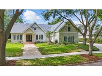 Beautiful suburban home with landscaped front yard and brick walkway at 6241 Blakeford Dr, Windermere, FL 34786