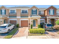 Two-story townhome with attached garage and landscaped front yard at 812 Park Grove Ct, Orlando, FL 32828
