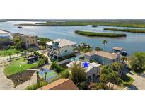 Aerial view of waterfront home with private dock and boat lift at 830 Garfish Ave, New Smyrna Beach, FL 32169