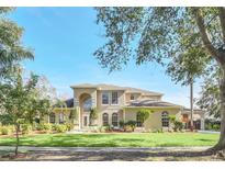 Two-story house with a landscaped lawn and driveway at 10125 Foxhurst Ct, Orlando, FL 32836
